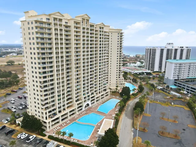 a front view of a house with a garden and parking