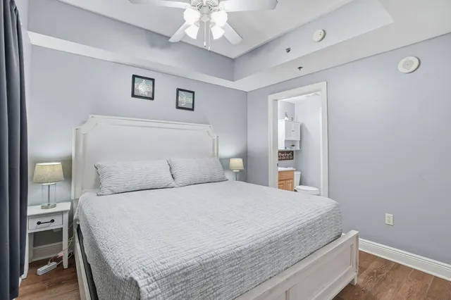 a bedroom with a large bed and a chandelier