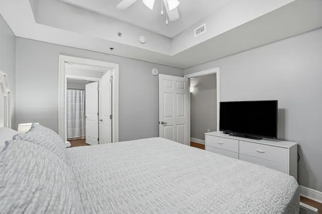 a bedroom with a flat screen tv and a bed