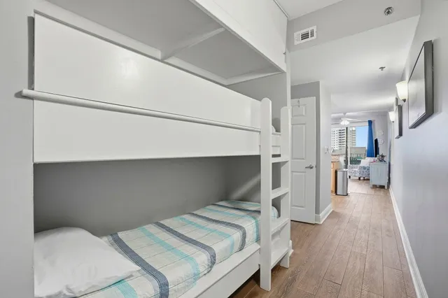 a bedroom with a bed and a refrigerator