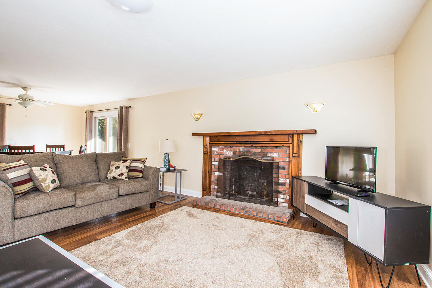 56 Daisy Hill Road Hyannis, MA 02601 - Photo 27 of 38 a living room with furniture a flat screen tv and a fireplace