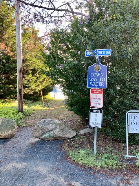 56 Daisy Hill Road Hyannis, MA 02601 - Photo 29 of 38 a street sign on a sidewalk next to a road