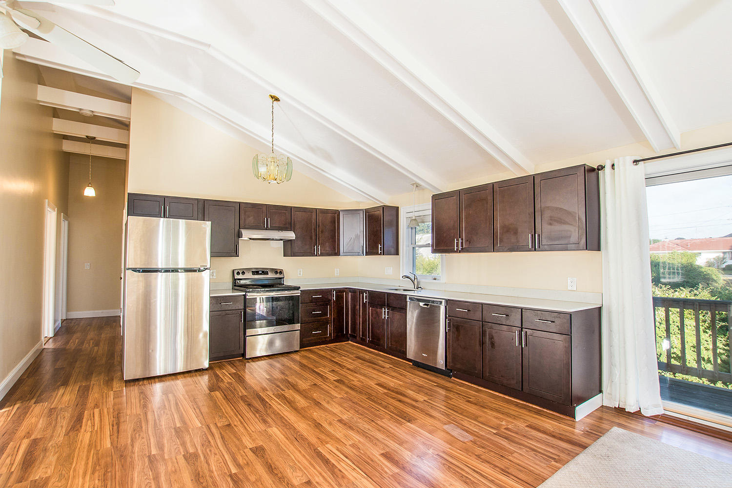 56 Daisy Hill Road Hyannis, MA 02601 - Photo 9 of 38 a kitchen with stainless steel appliances granite countertop a refrigerator a sink dishwasher a stove with wooden cabinets and floor