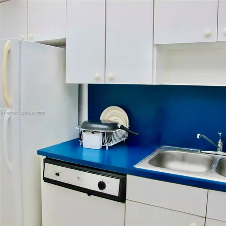 a kitchen with cabinets and white appliances