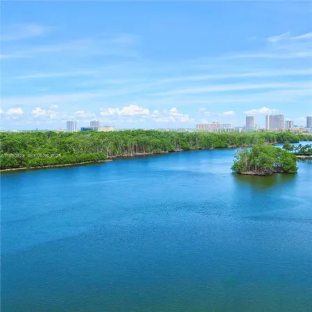 a view of a lake with houses in the back