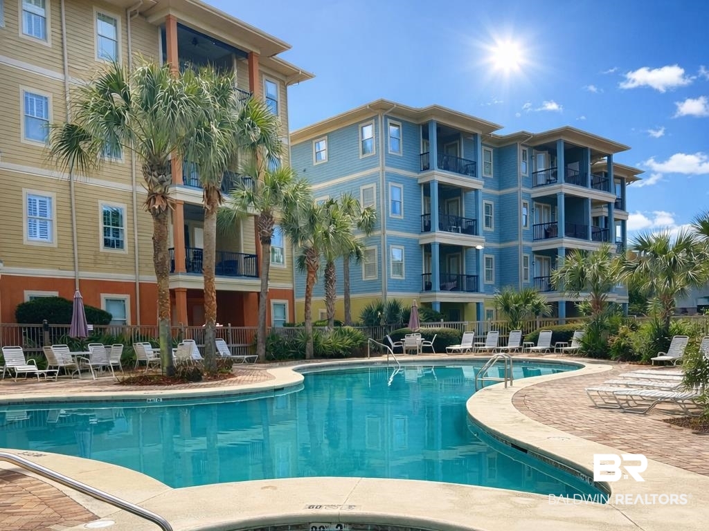 1430 Regency Road, Unit C101 Gulf Shores, AL 36542 - Photo 31 of 32 Community pool with a patio area