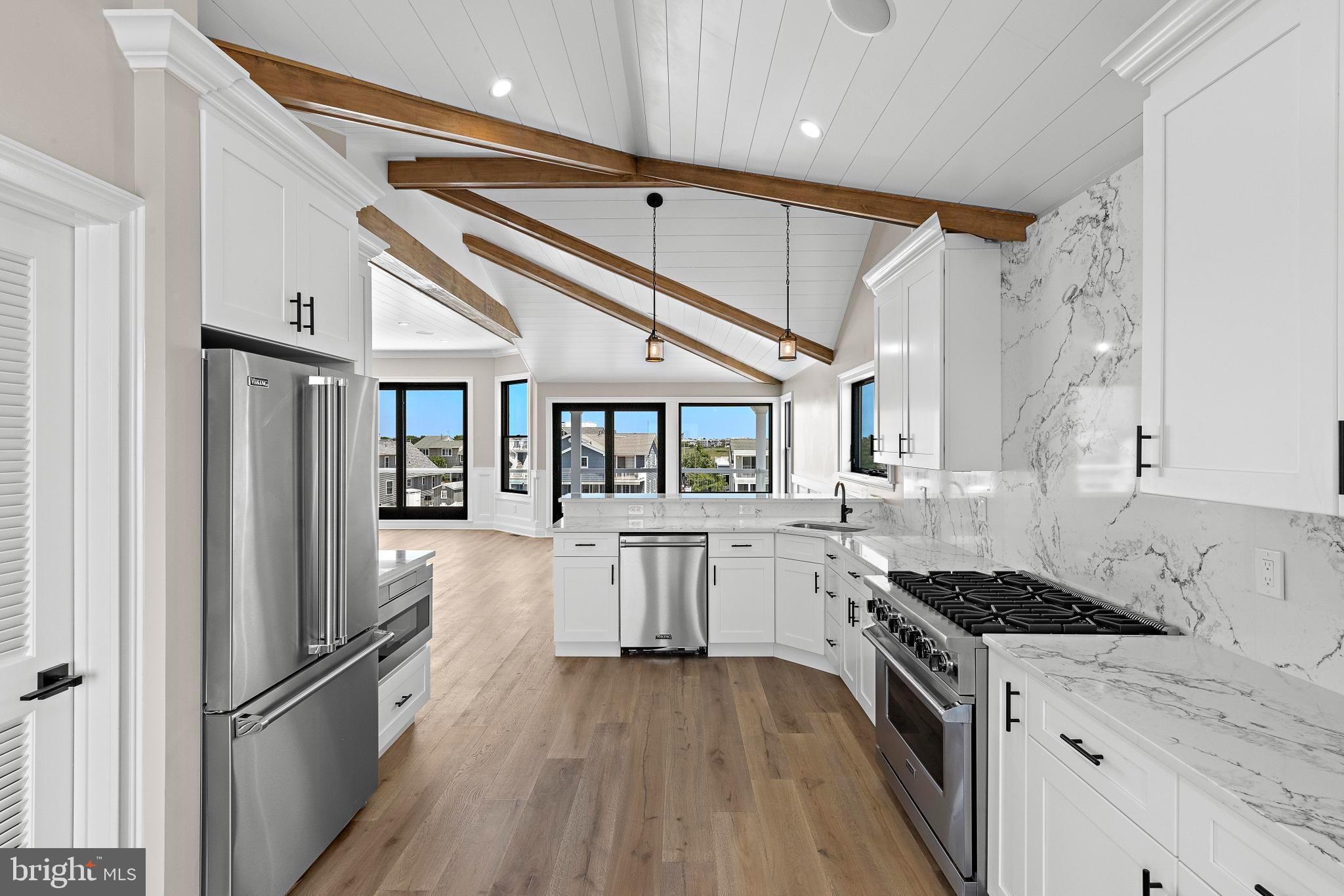 17 Butler Road Long Beach Township, NJ 08006 - Photo 25 of 110 a kitchen with stainless steel appliances granite countertop a stove and a refrigerator