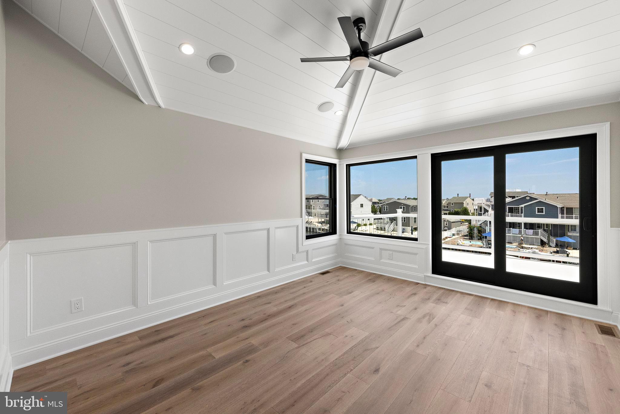 17 Butler Road Long Beach Township, NJ 08006 - Photo 43 of 110 a view of an empty room with a window and wooden floor