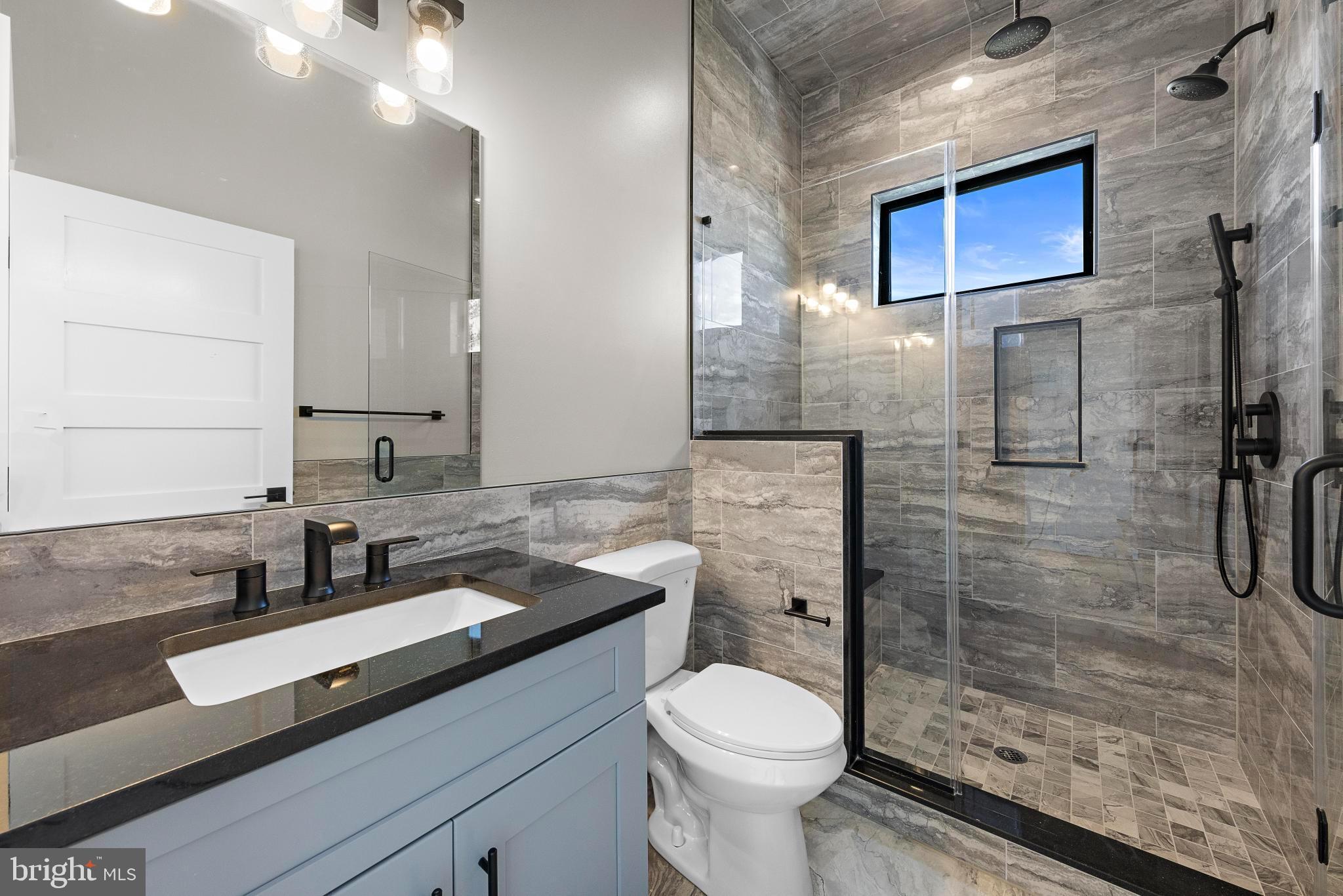17 Butler Road Long Beach Township, NJ 08006 - Photo 52 of 110 a bathroom with a granite countertop sink toilet and shower
