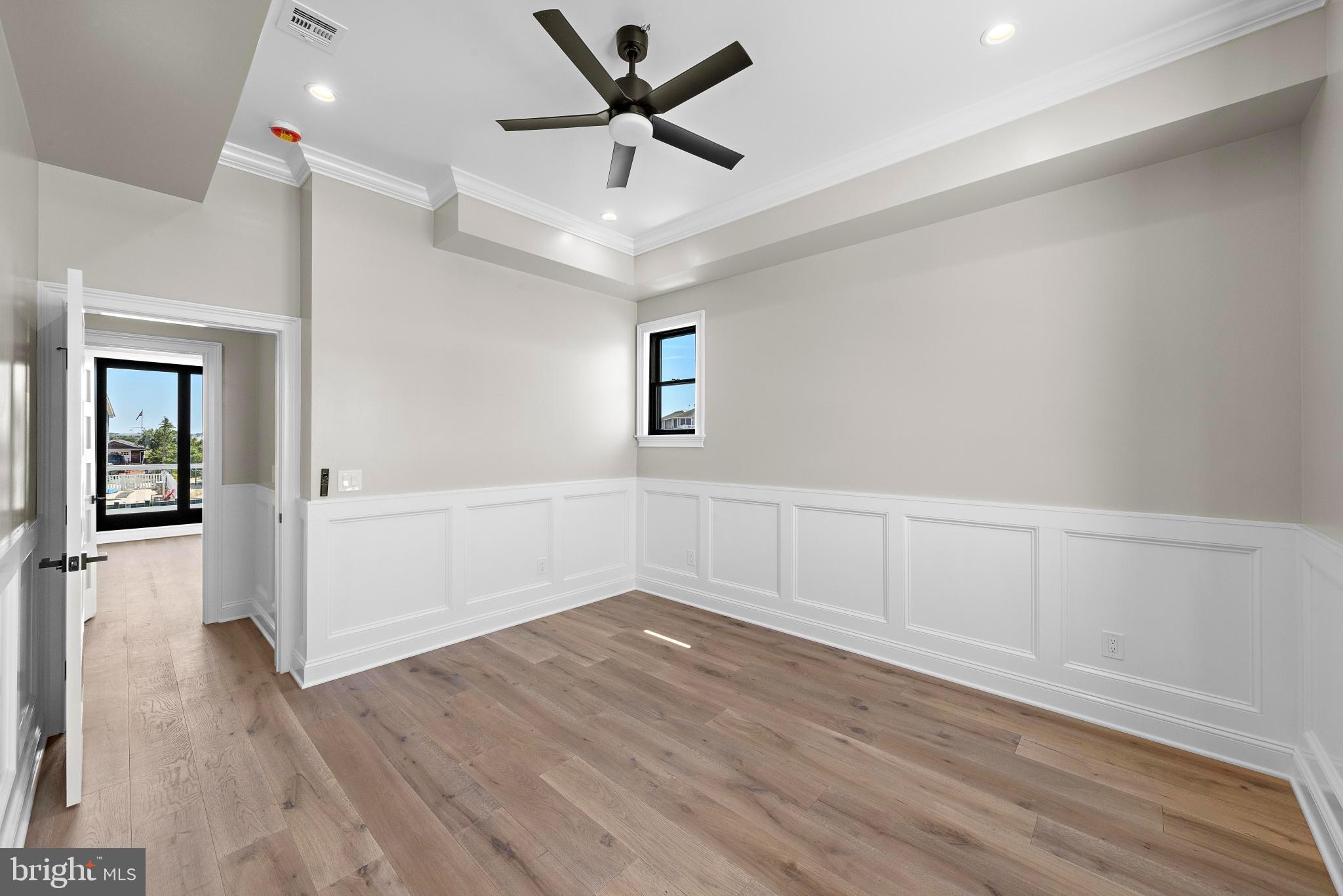 17 Butler Road Long Beach Township, NJ 08006 - Photo 57 of 110 an empty room with wooden floor and windows
