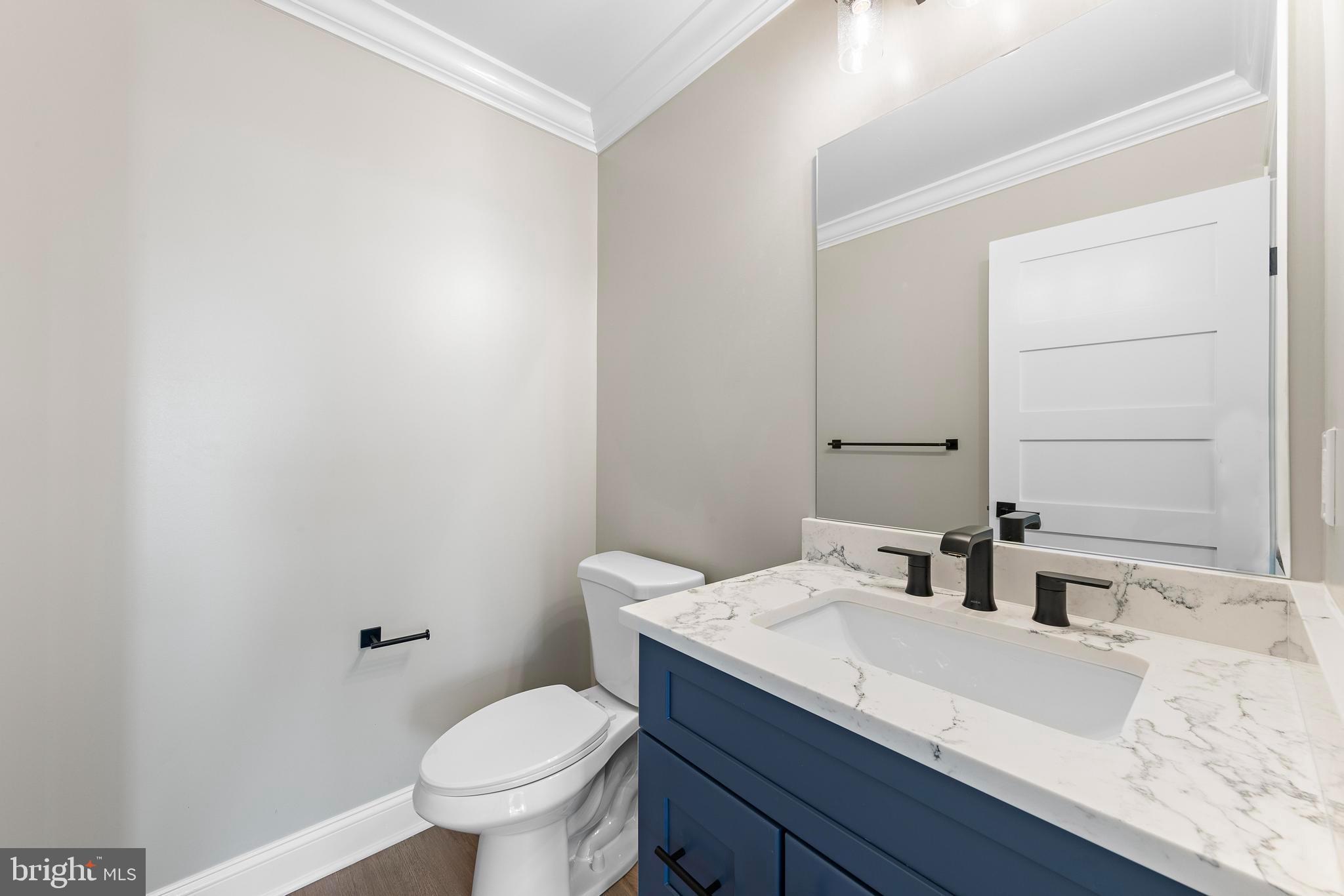 17 Butler Road Long Beach Township, NJ 08006 - Photo 62 of 110 a bathroom with a granite countertop sink a toilet and a mirror
