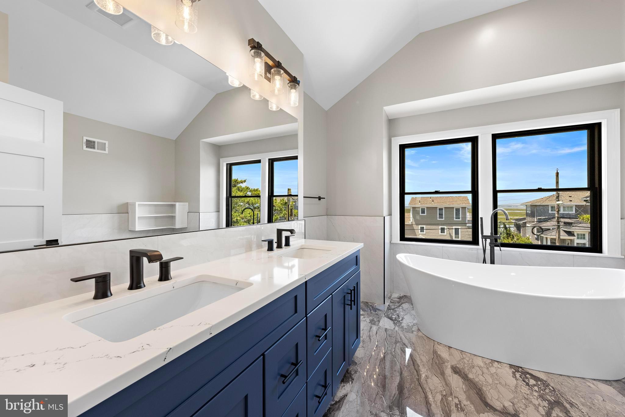 17 Butler Road Long Beach Township, NJ 08006 - Photo 64 of 110 a bathroom with a tub double sink window and mirror