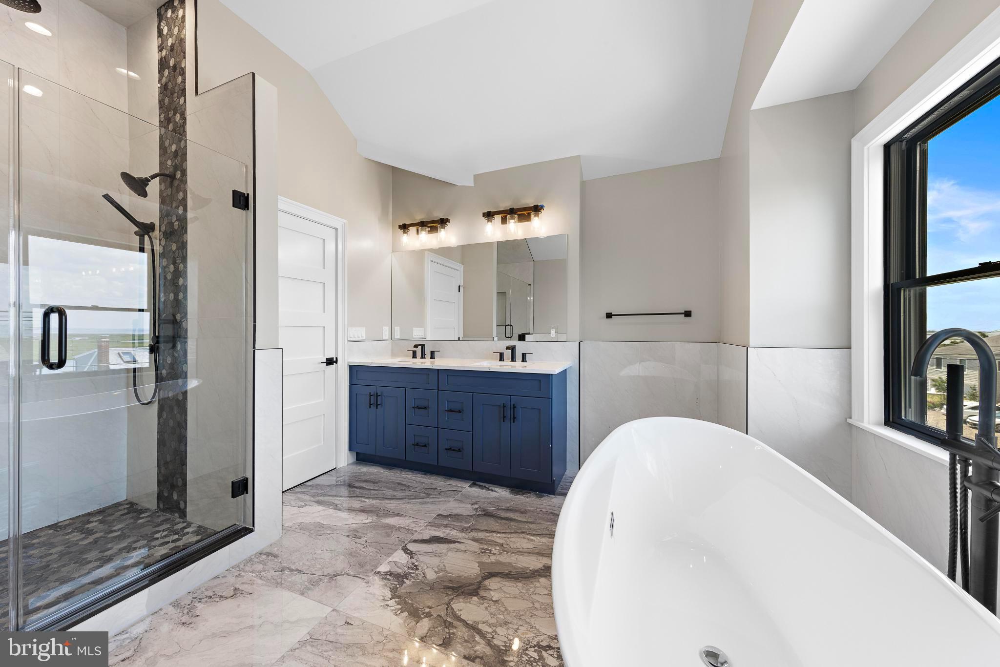 17 Butler Road Long Beach Township, NJ 08006 - Photo 65 of 110 a bathroom with a tub sink and mirror