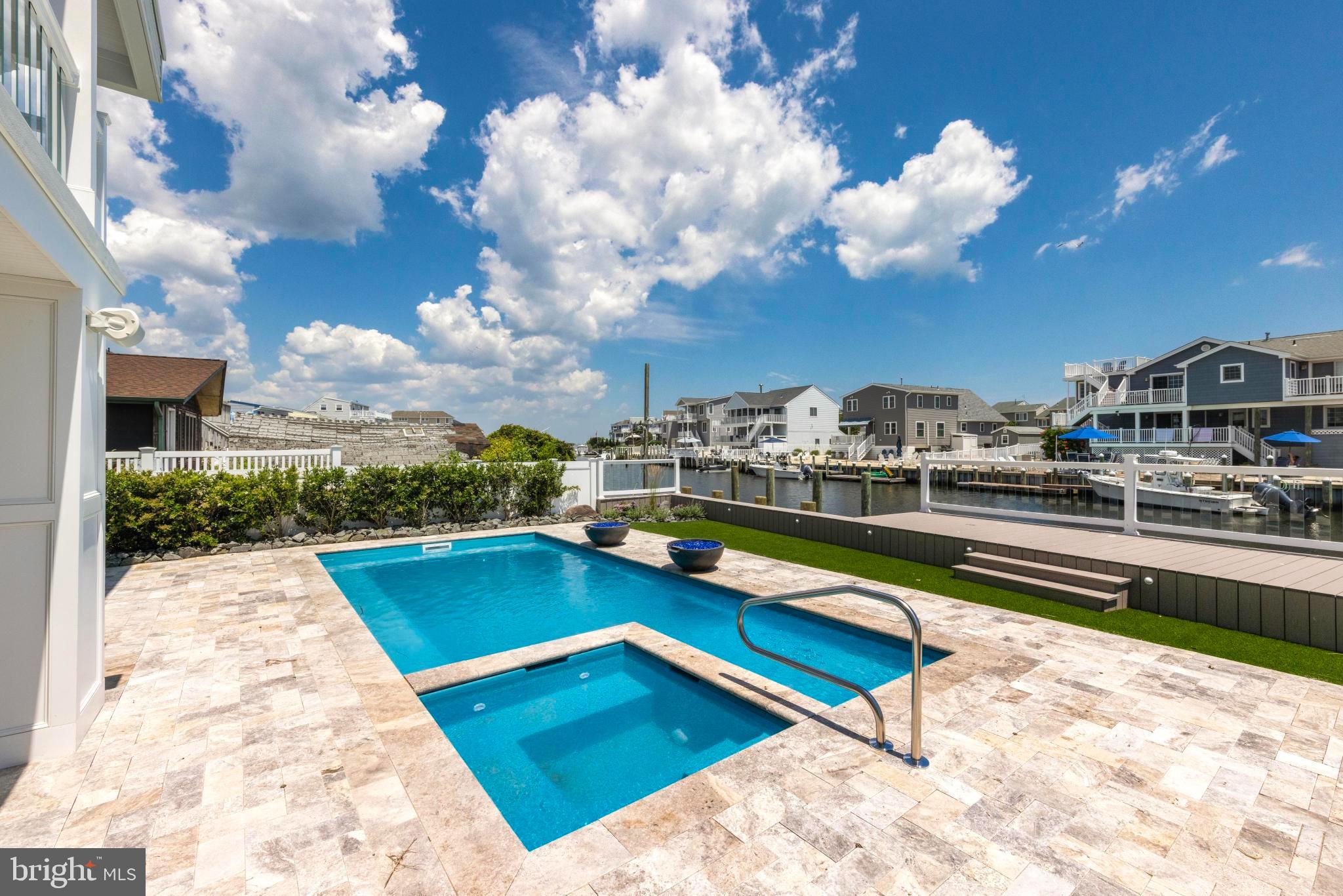 17 Butler Road Long Beach Township, NJ 08006 - Photo 77 of 110 a view of swimming pool with outdoor seating and city view