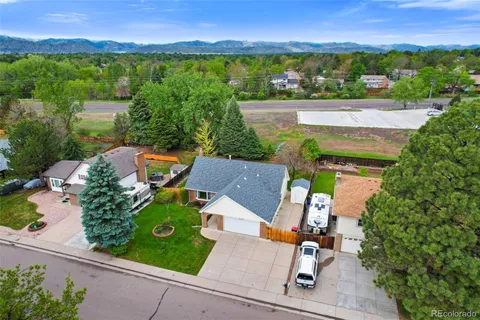 an aerial view of a house with garden space and outdoor seating