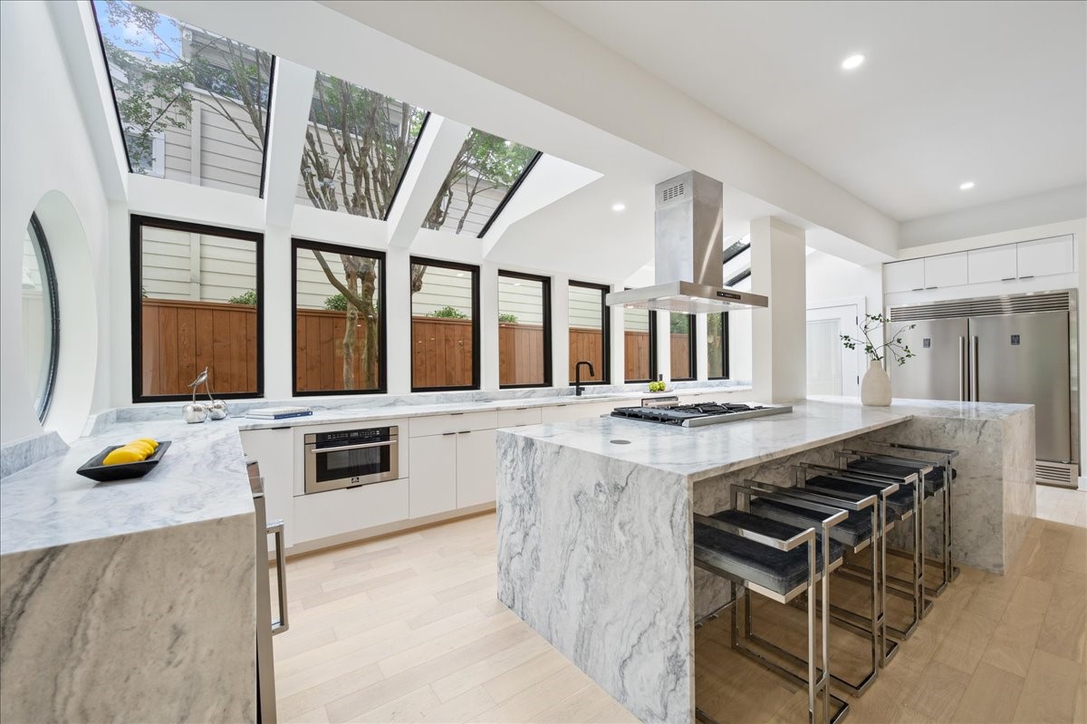 a kitchen with a stove and wooden cabinets