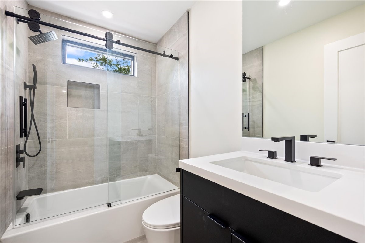 2135 Quenby Street Houston, TX 77005 - Photo 24 of 48 a bathroom with a bathtub shower sink vanity and toilet