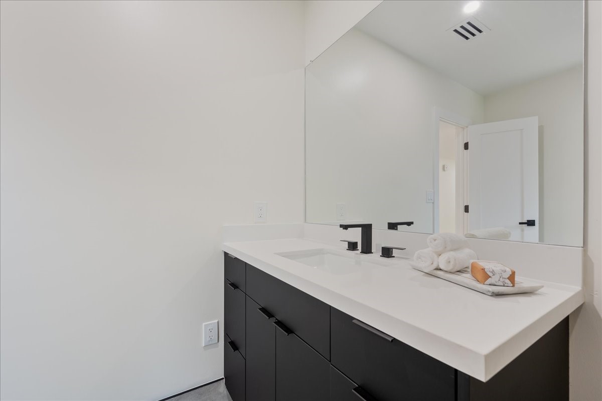 2135 Quenby Street Houston, TX 77005 - Photo 25 of 48 a bathroom with a sink and a mirror