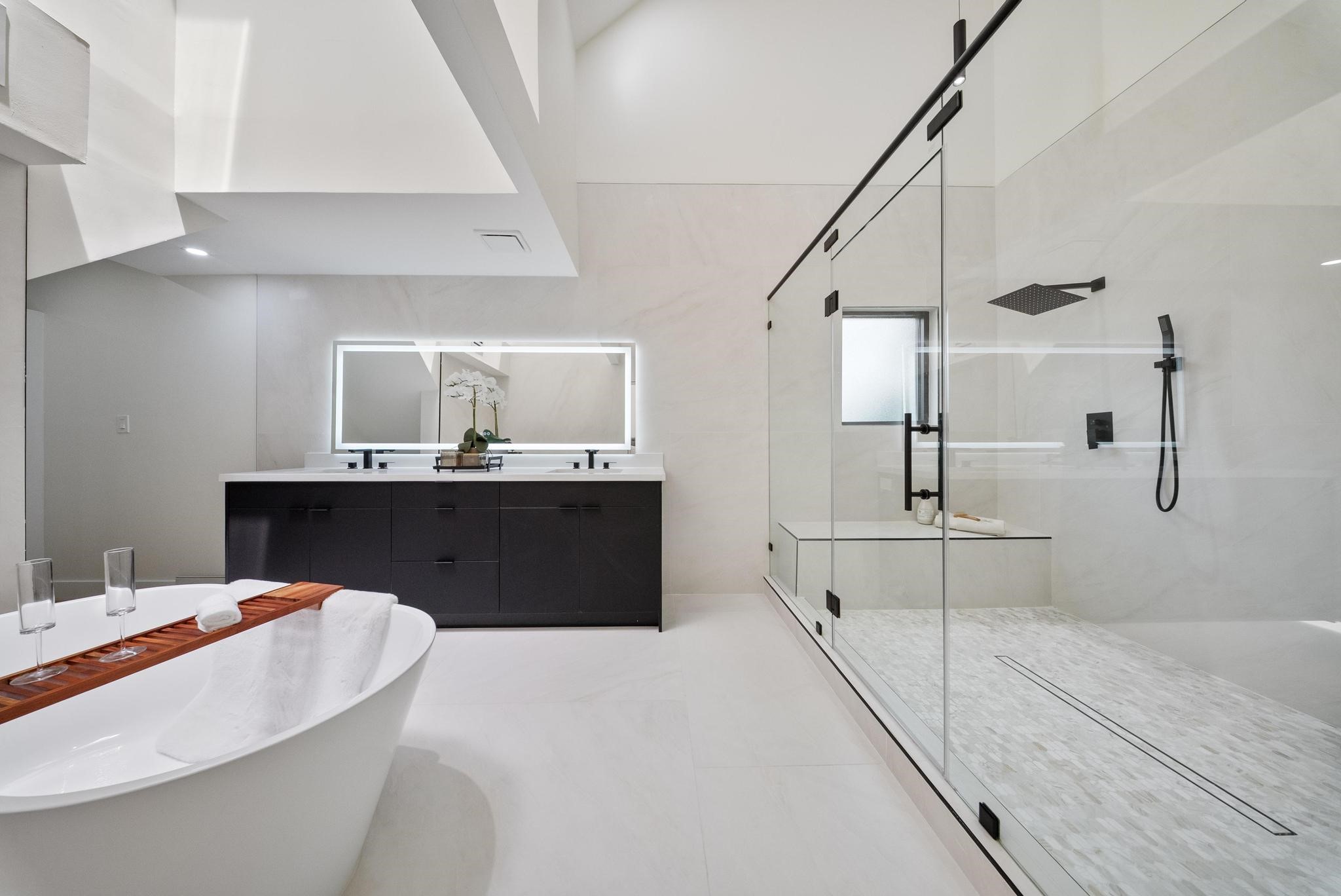 2135 Quenby Street Houston, TX 77005 - Photo 33 of 48 a spacious bathroom with a double vanity sink and a mirror