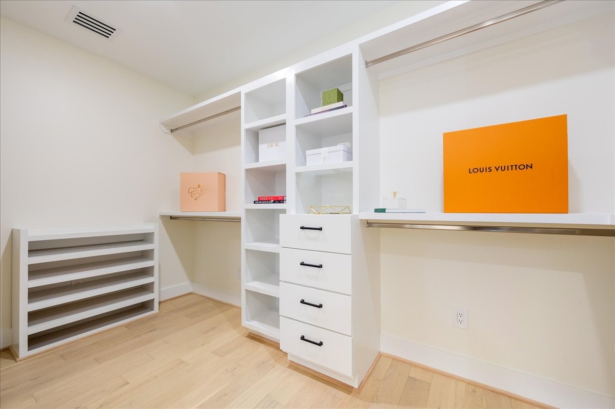 2135 Quenby Street Houston, TX 77005 - Photo 35 of 48 a view of walk in closet with empty racks