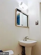 a bathroom with a sink mirror and toilet