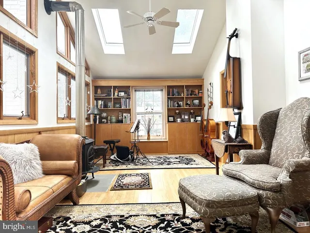 a living room with furniture fireplace and a large window