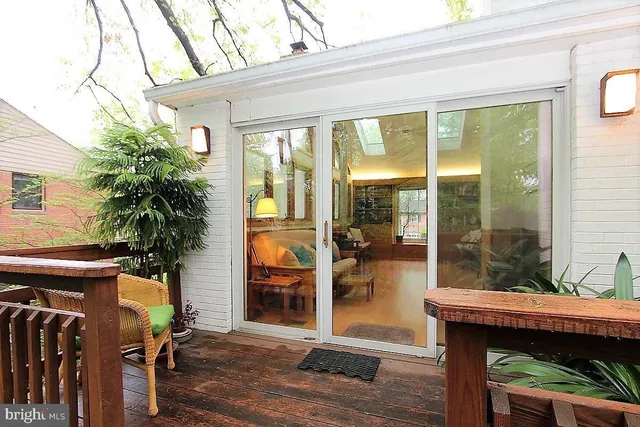 a view of a patio with table and chairs and potted plants