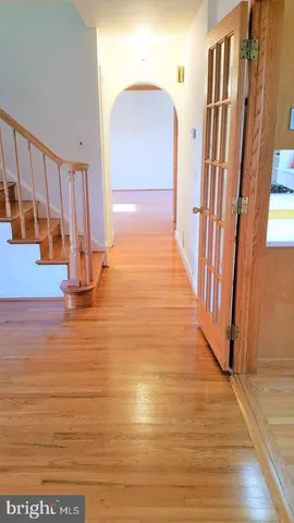 a view of front door and hallway with wooden floor
