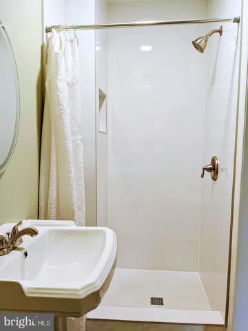 a bathroom with a shower and a sink