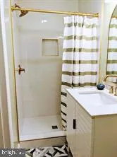 a bathroom with a shower and a sink