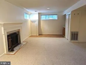 a view of empty room with windows and fireplace
