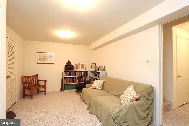 a living room with furniture and a bookshelf