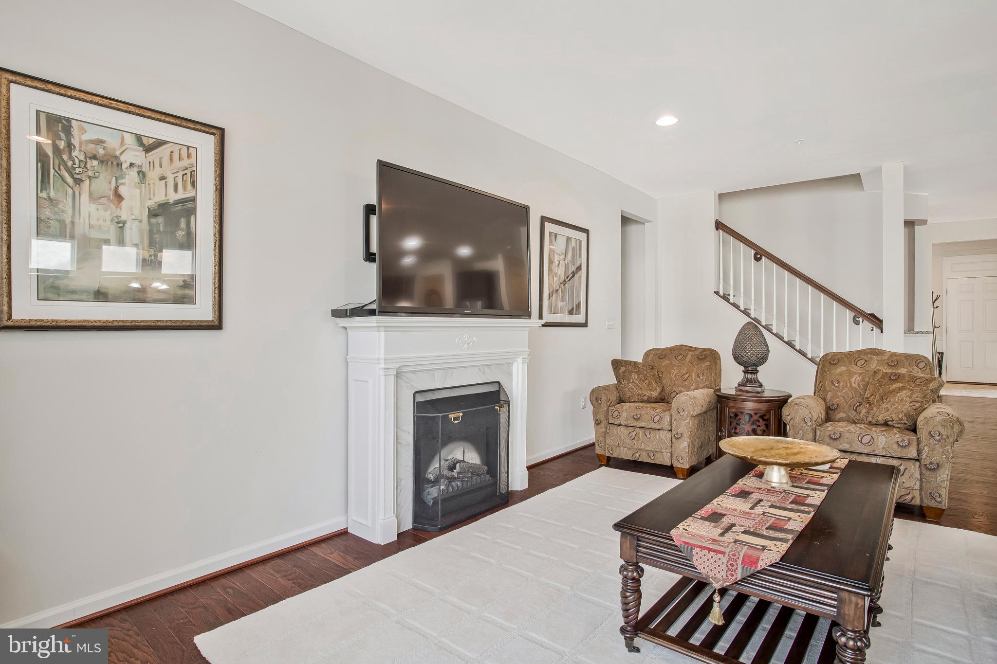 2123 Nottoway Drive Hanover, MD 21076 - Photo 16 of 57 a living room with furniture a flat screen tv and a fireplace