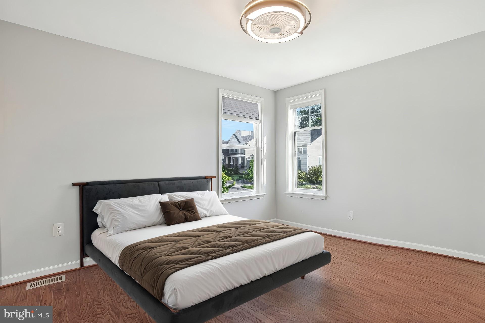 2123 Nottoway Drive Hanover, MD 21076 - Photo 33 of 57 a bedroom with a large bed and wooden floor