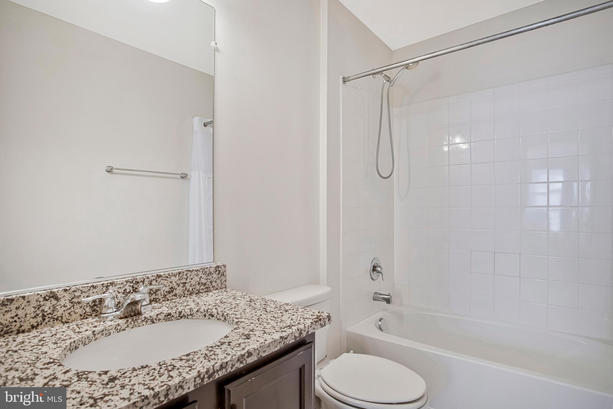 2123 Nottoway Drive Hanover, MD 21076 - Photo 35 of 57 a bathroom with a granite countertop sink toilet and shower