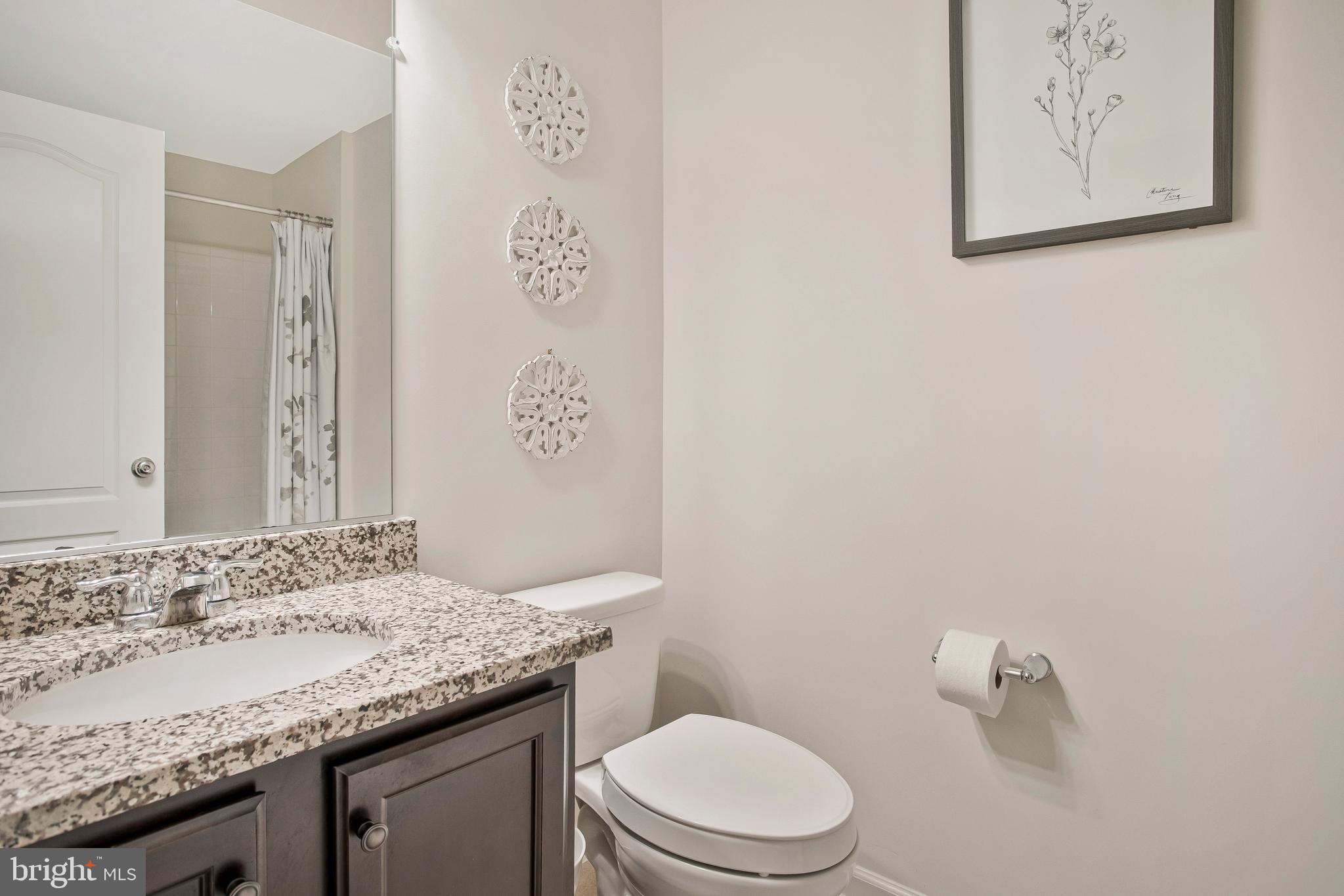2123 Nottoway Drive Hanover, MD 21076 - Photo 38 of 57 a bathroom with a granite countertop sink and a toilet