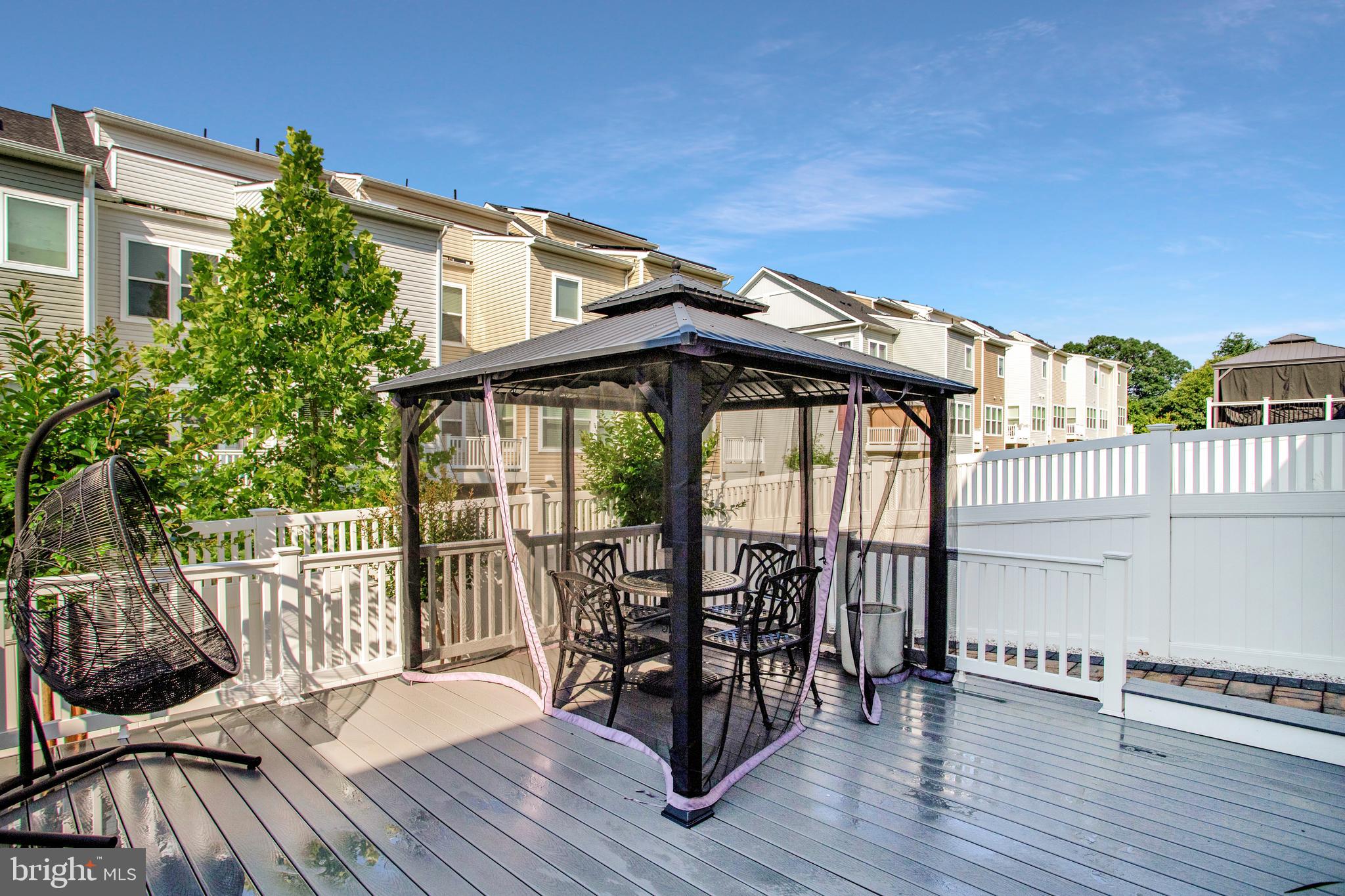 2123 Nottoway Drive Hanover, MD 21076 - Photo 47 of 57 a patio with wooden floor a yard a table and chairs