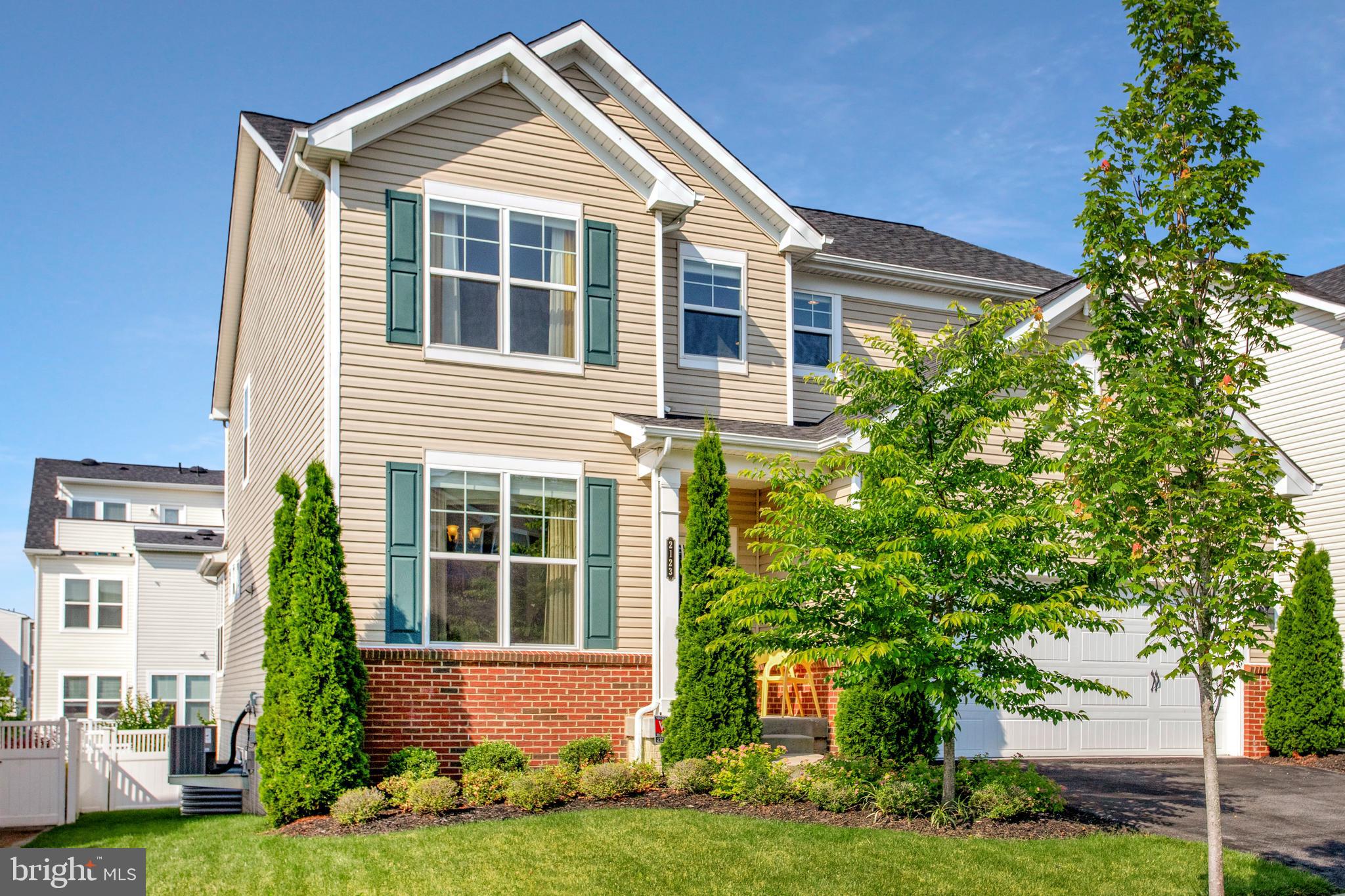 2123 Nottoway Drive Hanover, MD 21076 - Photo 56 of 57 a front view of a house with a yard and potted plants