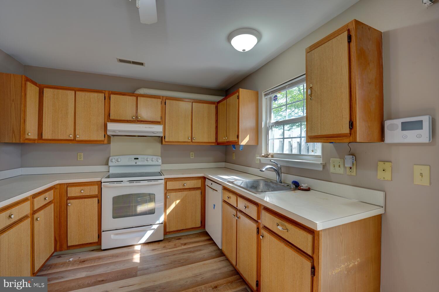 121 Periwinkle Drive Dover, DE 19904 - Photo 12 of 35 a kitchen with a sink stove top oven and cabinets