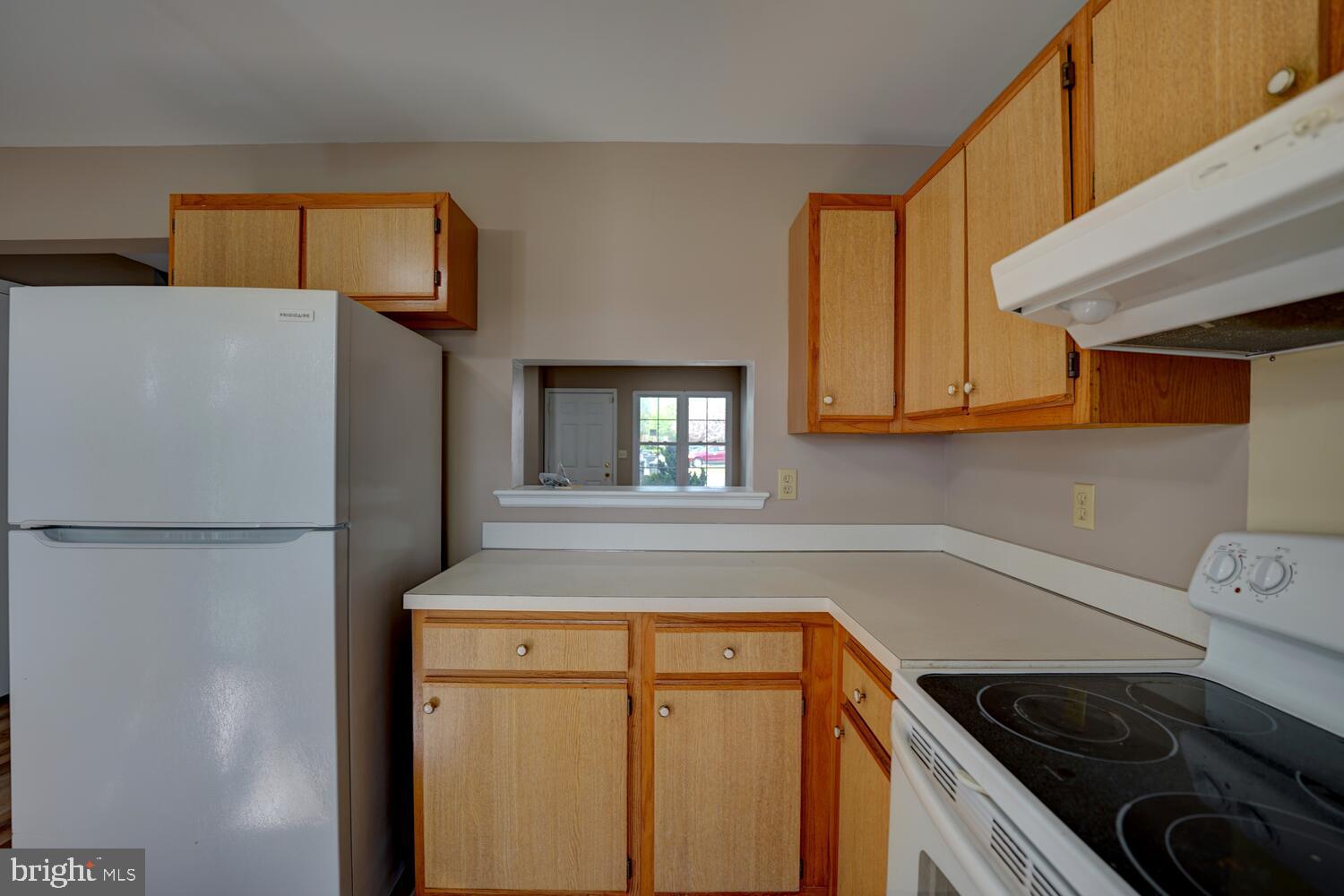 121 Periwinkle Drive Dover, DE 19904 - Photo 15 of 35 a kitchen with a refrigerator and a stove
