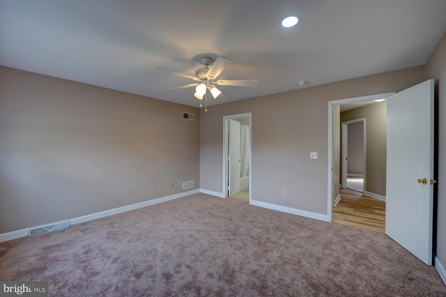 121 Periwinkle Drive Dover, DE 19904 - Photo 20 of 35 an empty room with a chandelier fan and a bathroom