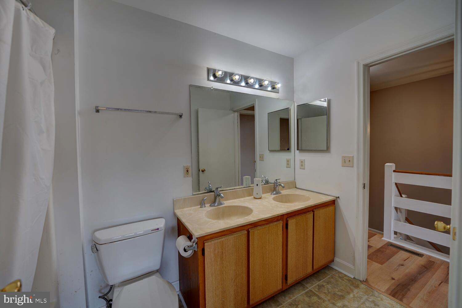 121 Periwinkle Drive Dover, DE 19904 - Photo 24 of 35 a bathroom with a sink a toilet and mirror