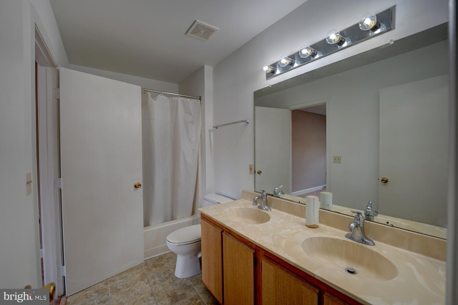 121 Periwinkle Drive Dover, DE 19904 - Photo 25 of 35 a bathroom with a double vanity sink a toilet and a mirror