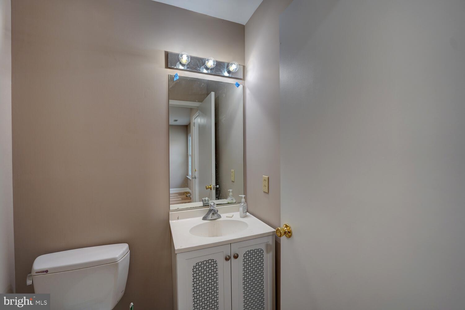121 Periwinkle Drive Dover, DE 19904 - Photo 28 of 35 a bathroom with a toilet sink and mirror