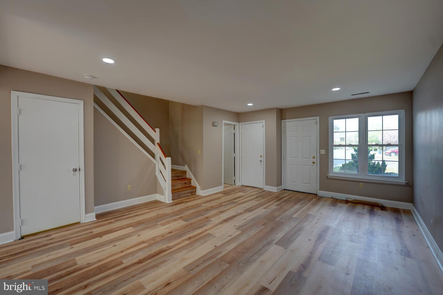 121 Periwinkle Drive Dover, DE 19904 - Photo 4 of 35 a view of an empty room with wooden floor and a window