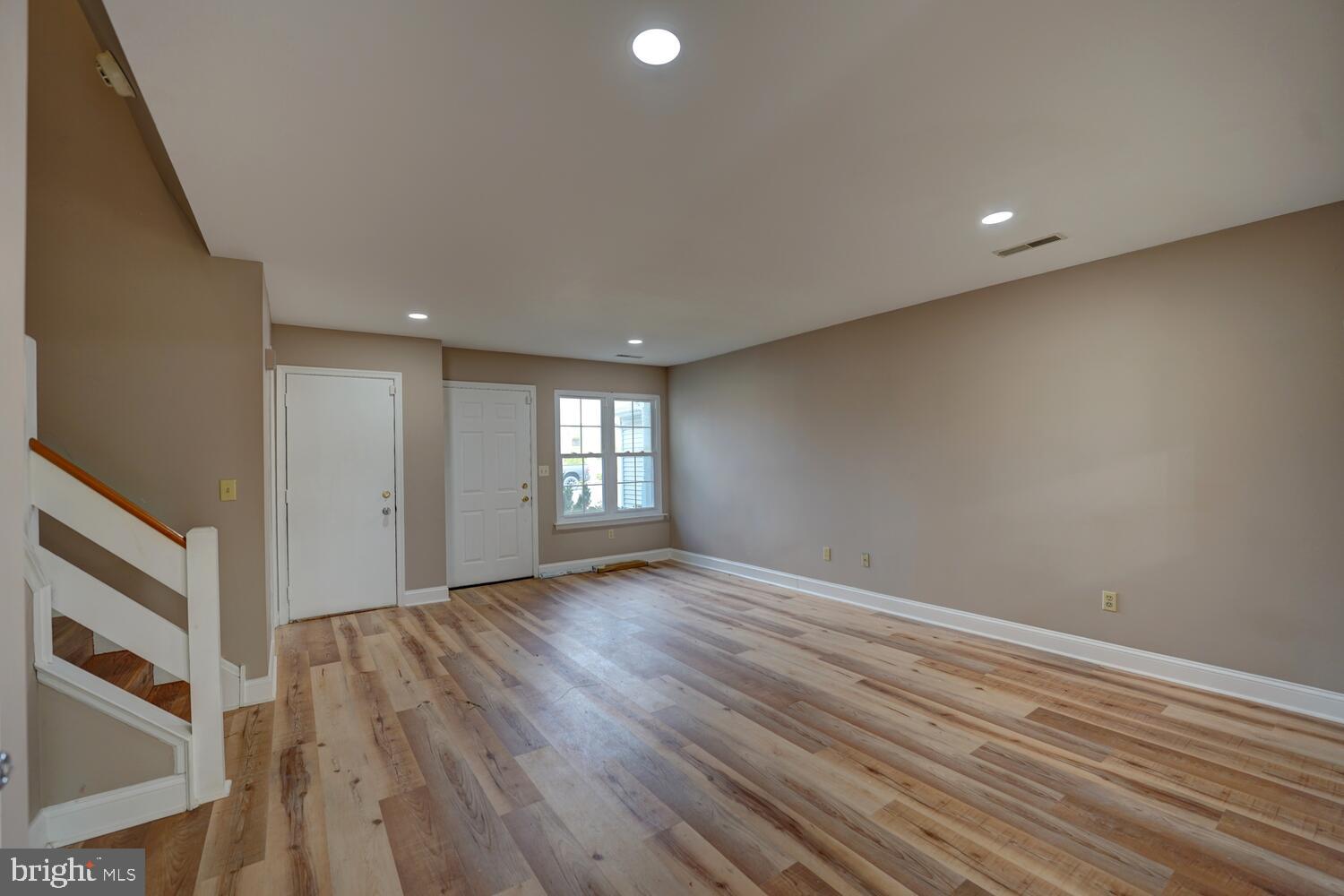 121 Periwinkle Drive Dover, DE 19904 - Photo 5 of 35 a view of an empty room with wooden floor and window