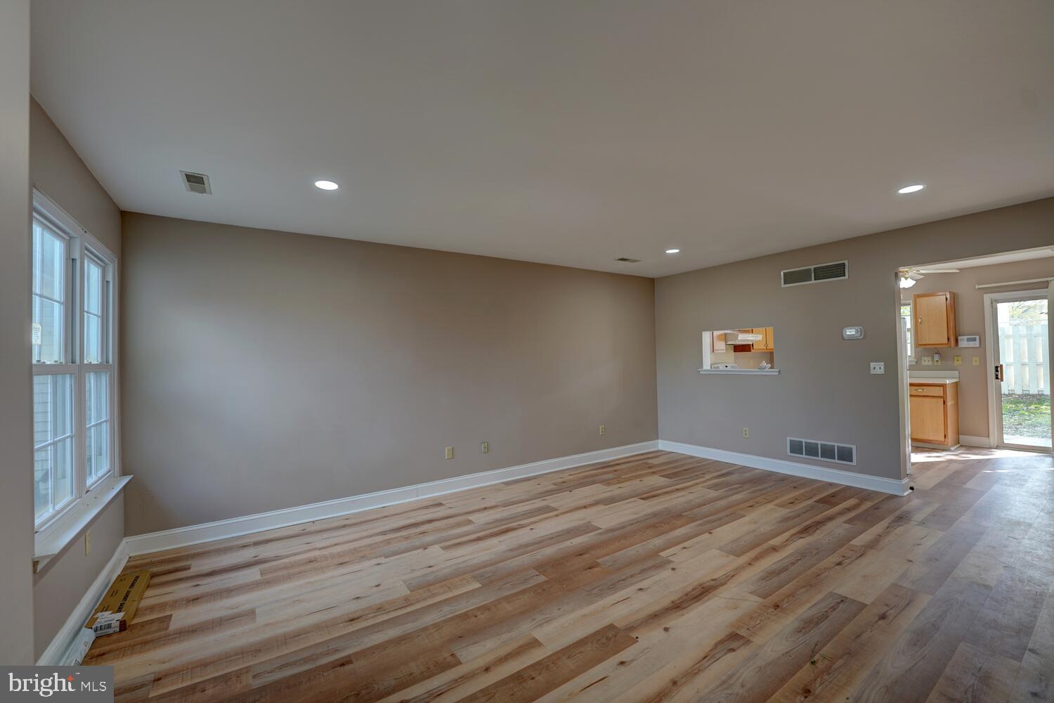 121 Periwinkle Drive Dover, DE 19904 - Photo 6 of 35 wooden floor in an empty room with a window