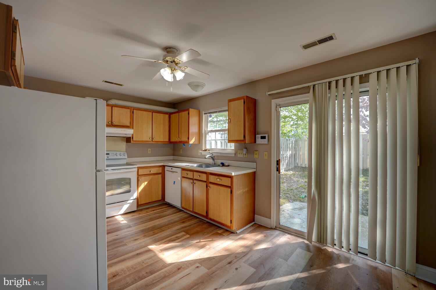 121 Periwinkle Drive Dover, DE 19904 - Photo 10 of 35 a kitchen with granite countertop a stove and a refrigerator