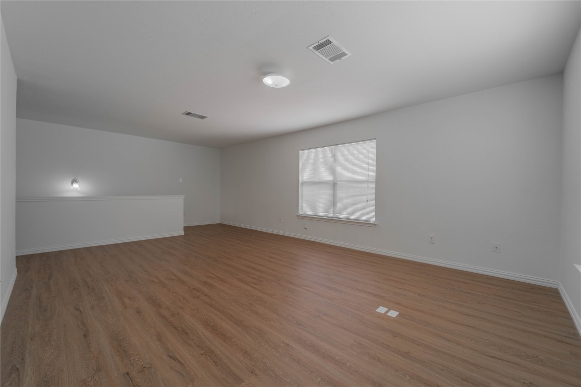 2000 Elk Ridge Cove Round Rock, TX 78665 - Photo 12 of 27 an empty room with wooden floor and windows