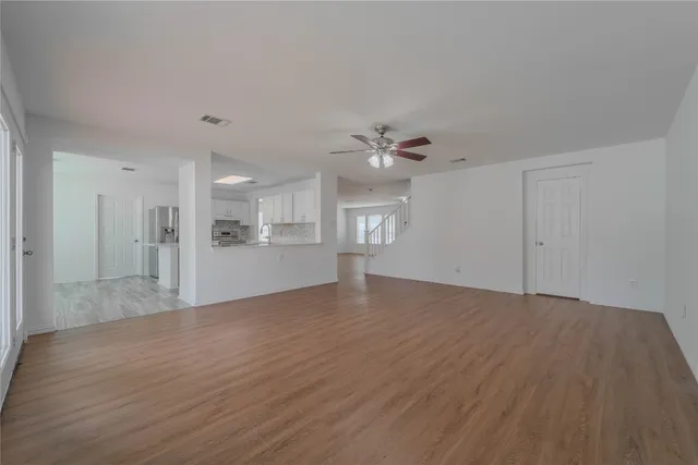 a view of an empty room with a kitchen